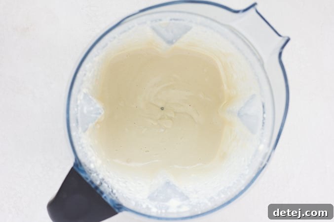 Smooth, blended cashew mayo in a blender jar, ready for the potato salad.