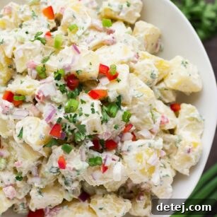 close up of vegan potato salad in white bowl