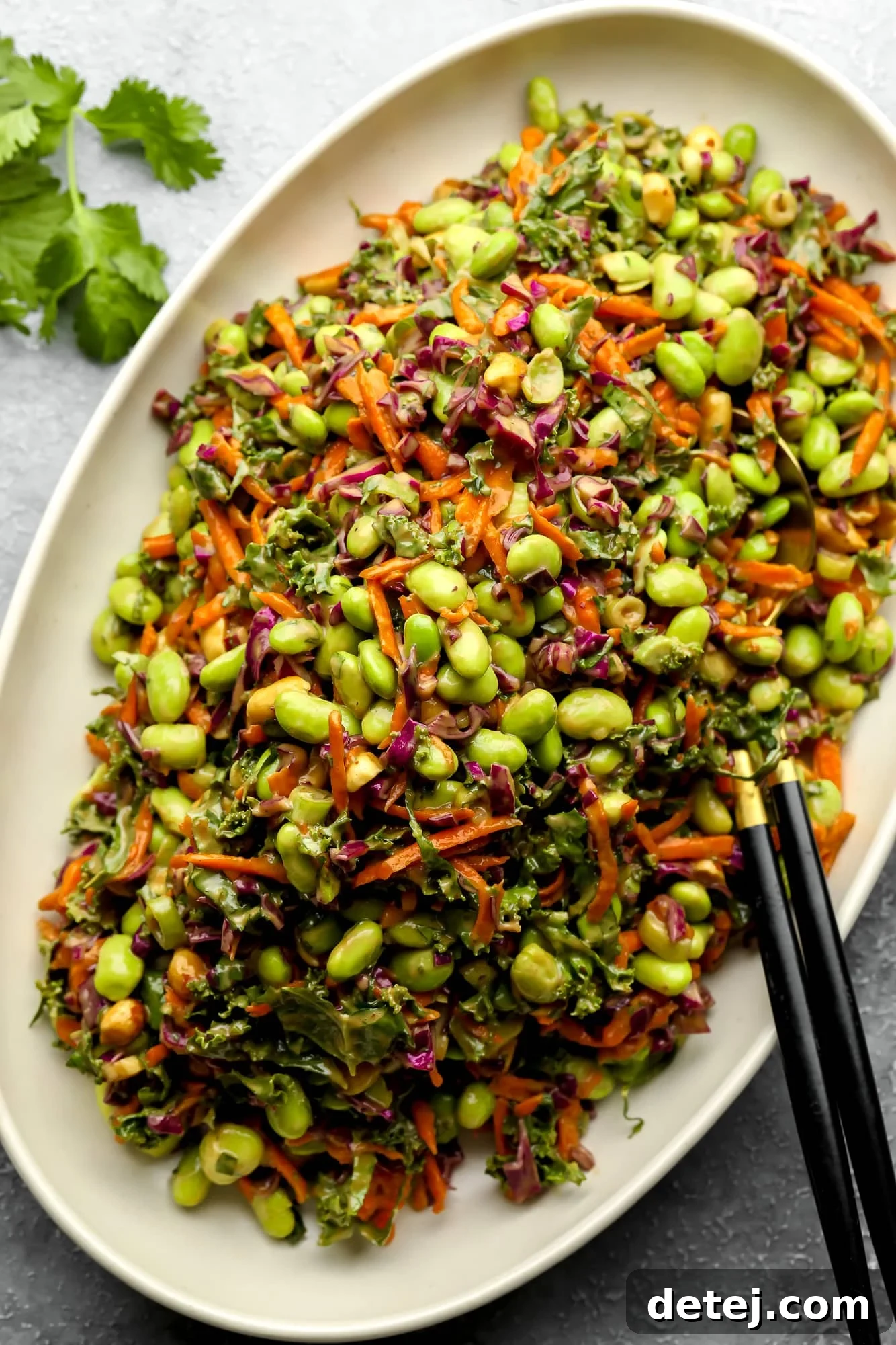 A large batch of Edamame Salad with Peanut Sauce displayed on an elegant white serving platter, ready to be enjoyed as a vibrant and high-protein vegan meal.