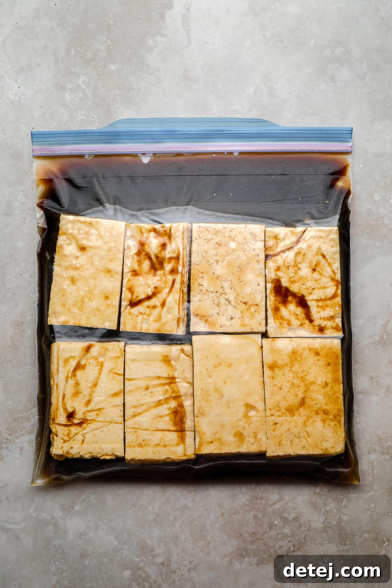 rectangular tofu pieces and a marinade in a large ziplock bag.