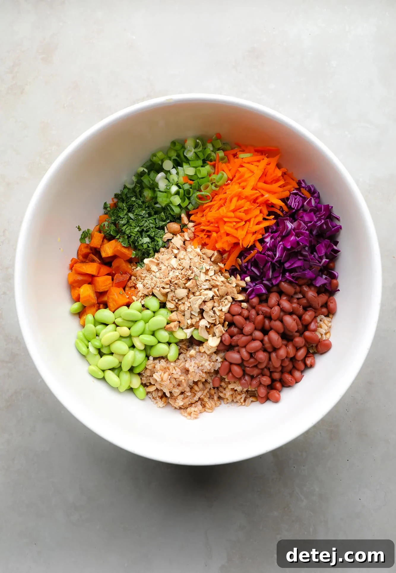 Spicy Peanut Farro Power Bowl 3 ingredients for farro salad together in a large white bowl.