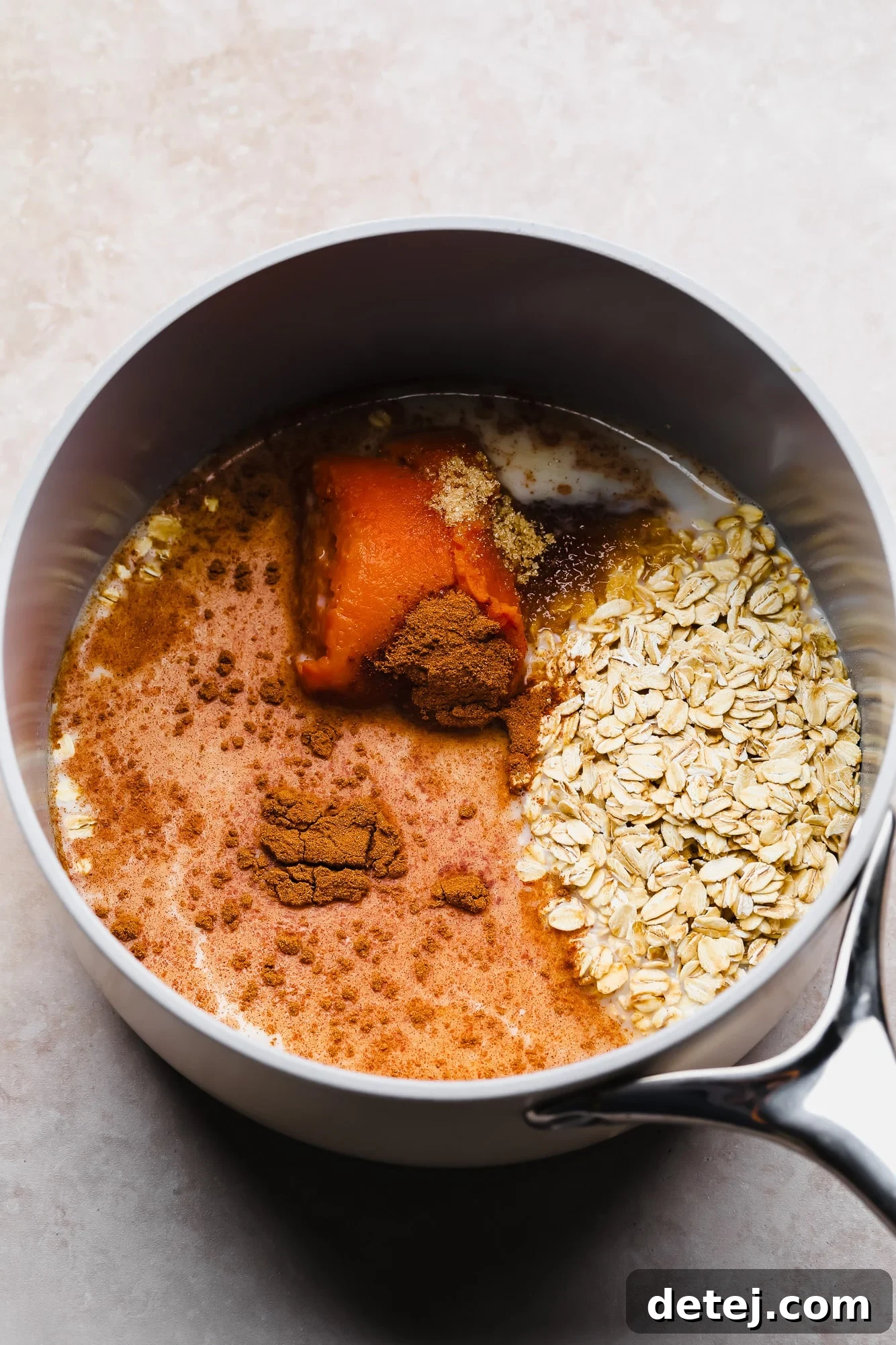 The simple ingredients for pumpkin oatmeal are gathered in a pot, ready for cooking.
