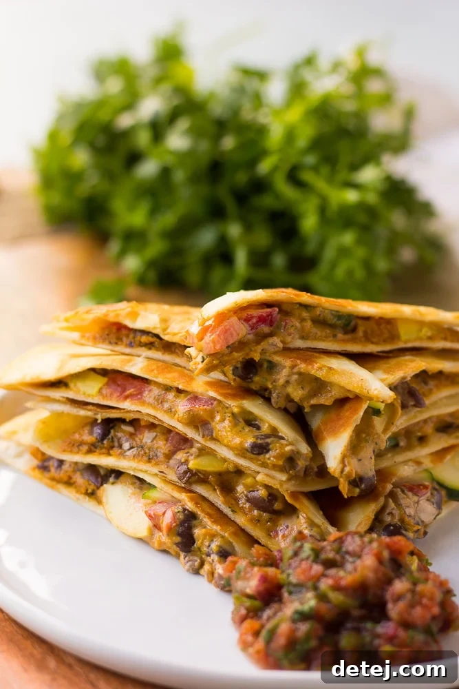 A stack of perfectly cooked Cheesy Vegan Quesadillas, ready to be enjoyed