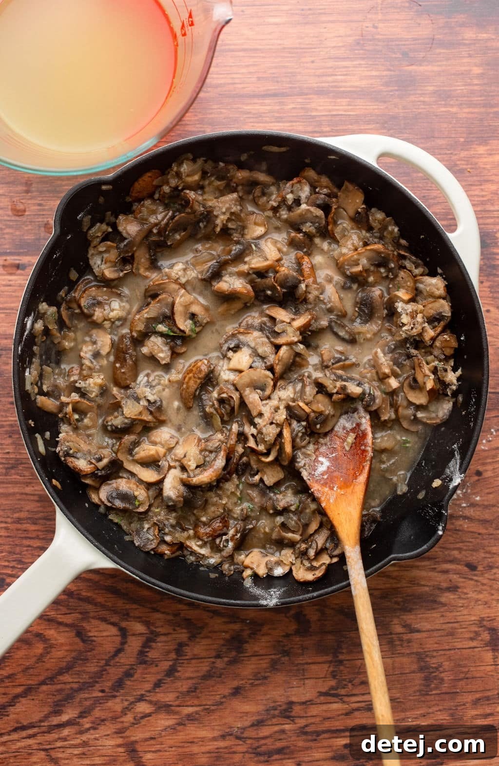 cooking mushrooms for mushroom gravy in a black skillet.