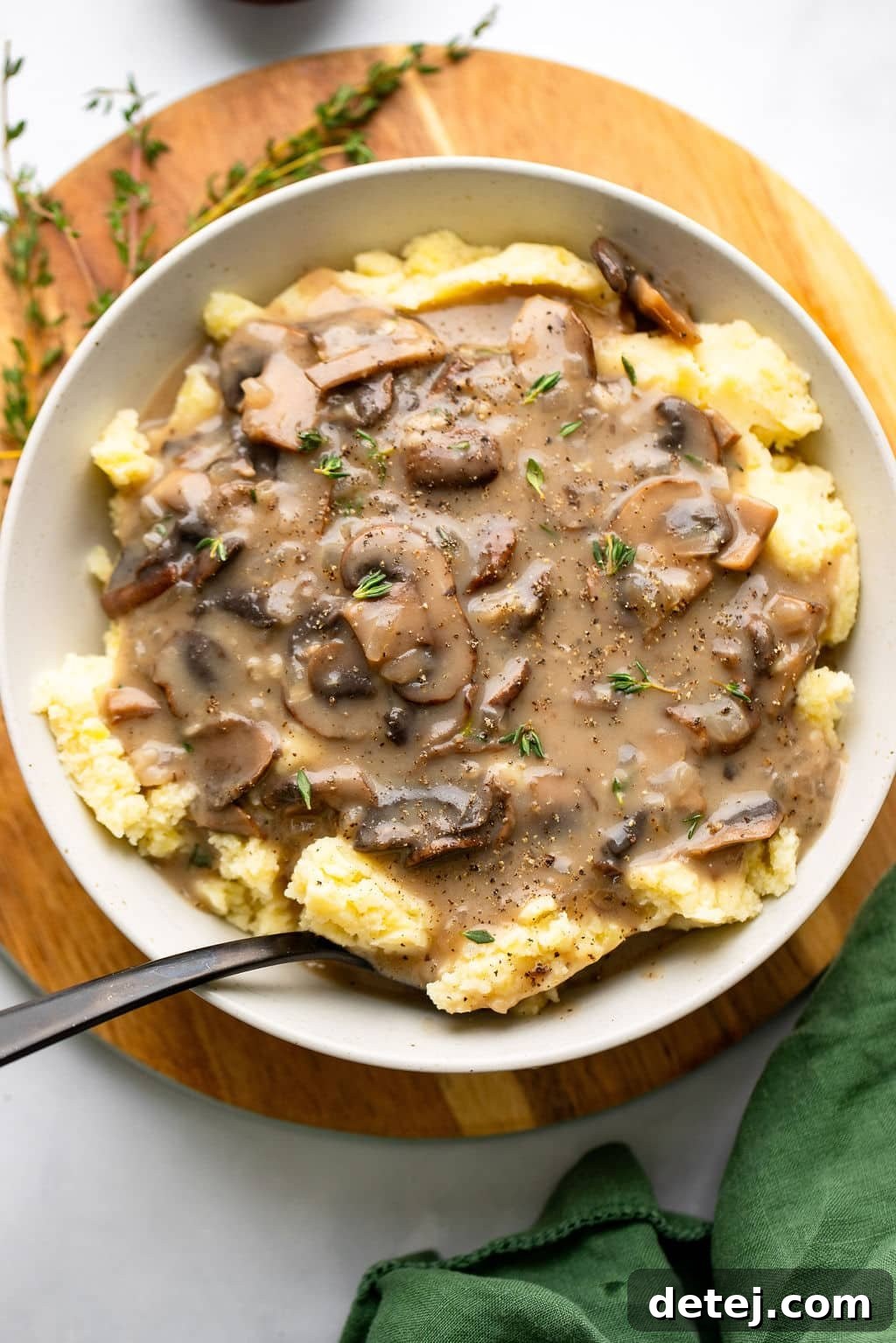 vegan mushroom gravy served over mashed potatoes in a white bowl.