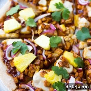 Hawaiian BBQ Vegan Pizza with barbecue tofu, pineapple, and red onion