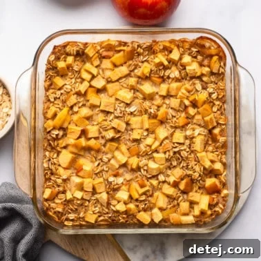 Warm Apple Oat Bake 10 Apple Baked Oatmeal in a glass baking dish, a perfect and easy vegan breakfast casserole.