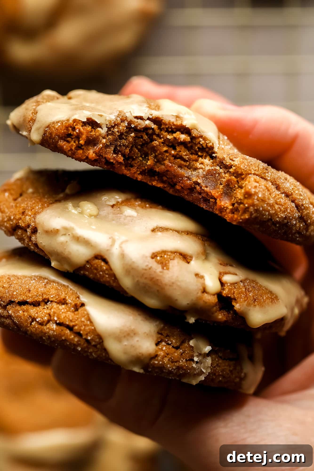 A woman's hand holding a stack of Gingerbread Latte Cookies.