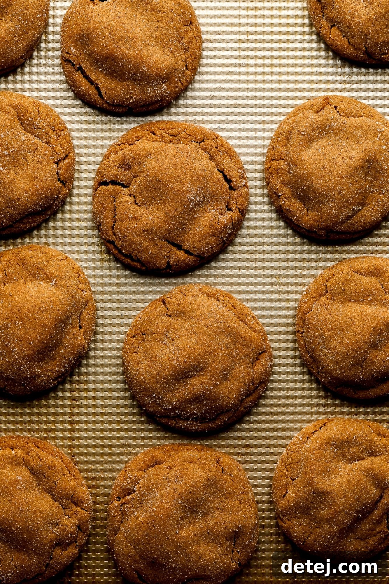 Baked gingerbread latte cookies on a metal baking pan.