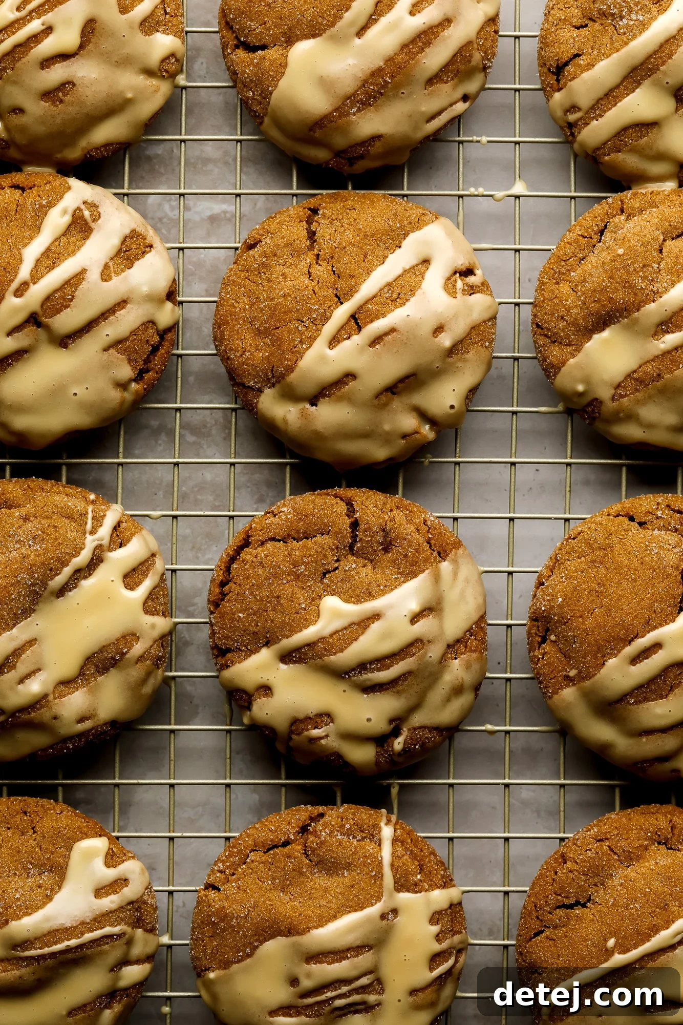 Gingerbread Latte Cookies drizzled with a white espresso glaze on a wire rack.