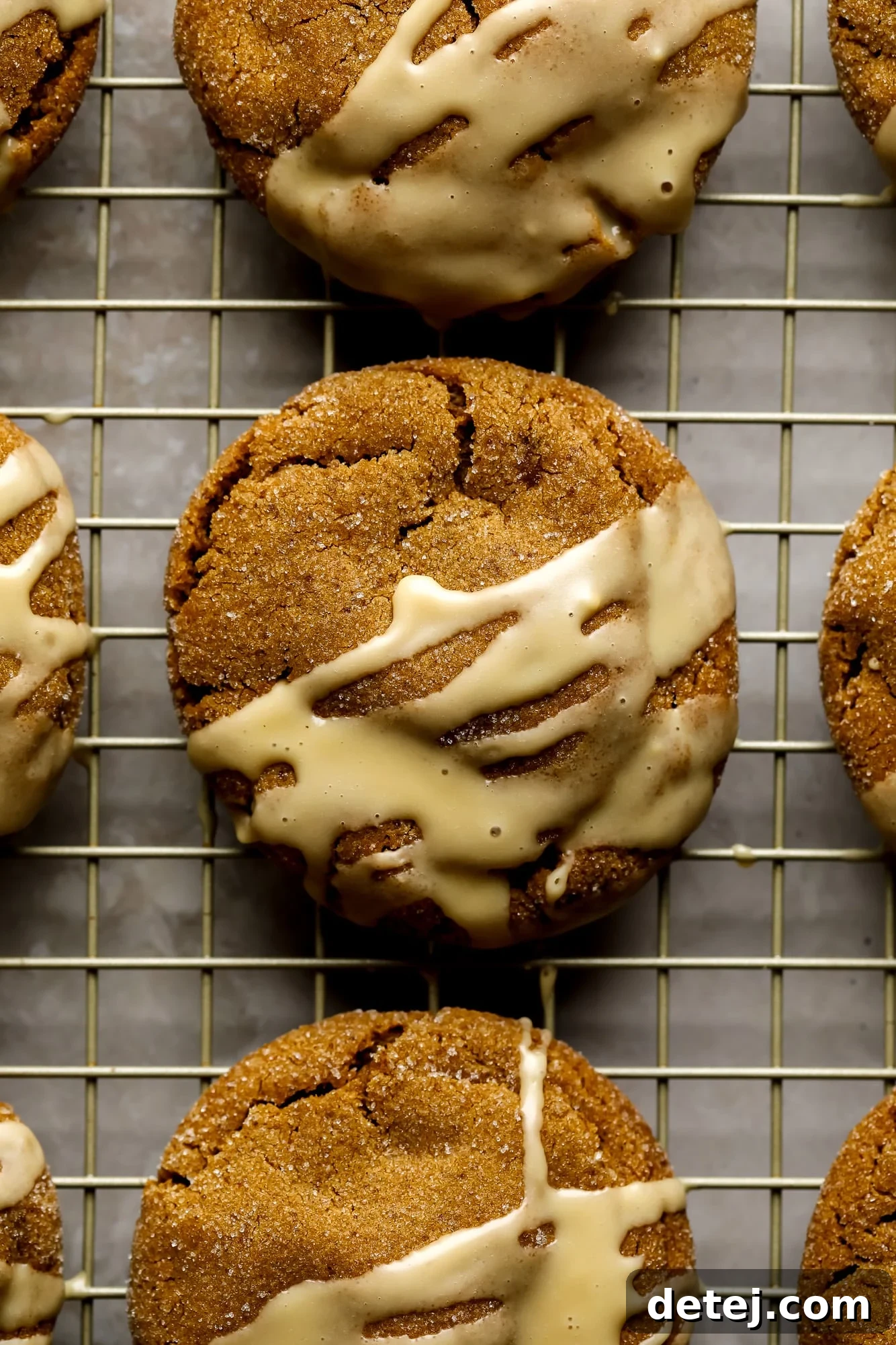 Gingerbread Latte Cookies drizzled with a white espresso glaze on a wire rack.