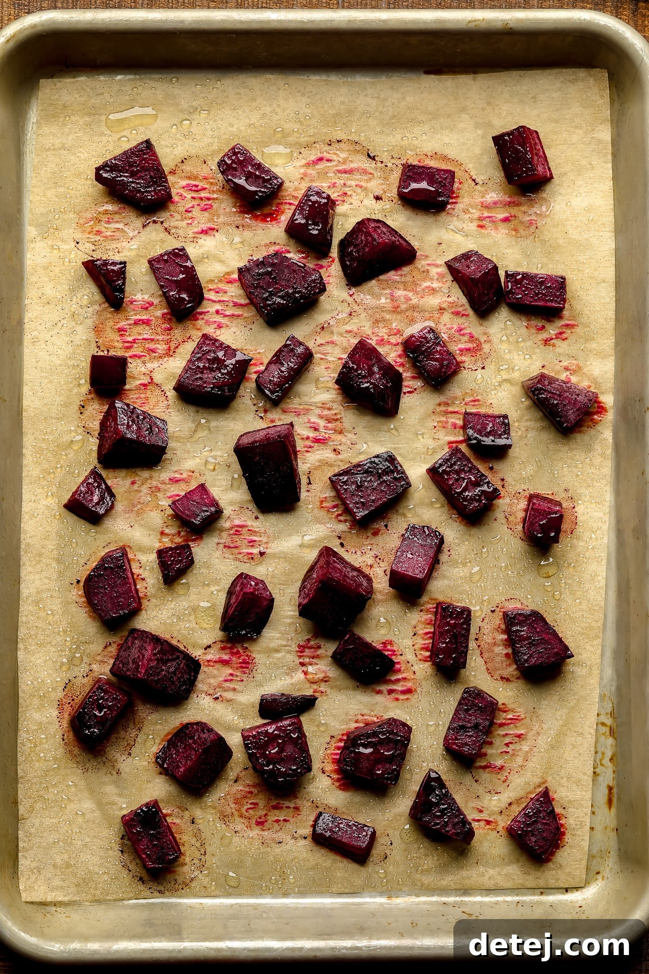 Ruby Red Hummus 3 Freshly chopped and roasted beets spread evenly on a baking sheet, ready for blending.