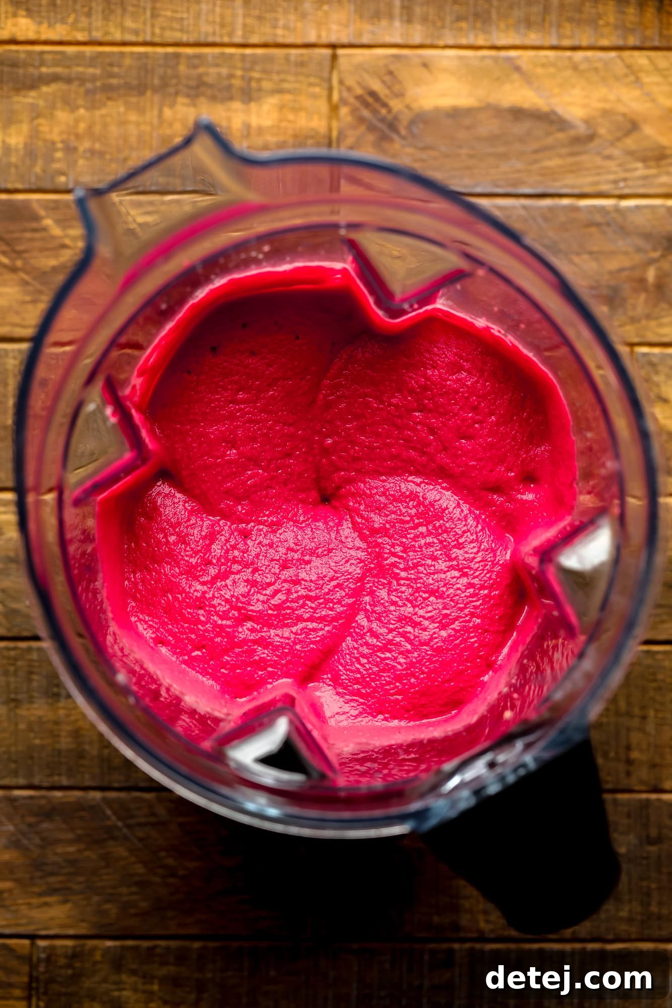 Ruby Red Hummus 5 The blender container filled with vibrant pink beet hummus, in the process of becoming perfectly smooth and creamy.