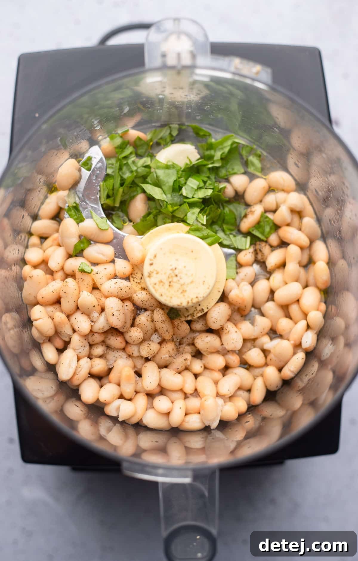 ingredients for white bean dip in a food processor.