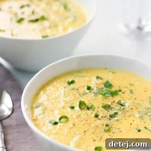 Two bowls of super creamy vegan cauliflower kale soup, ready to serve and enjoy.