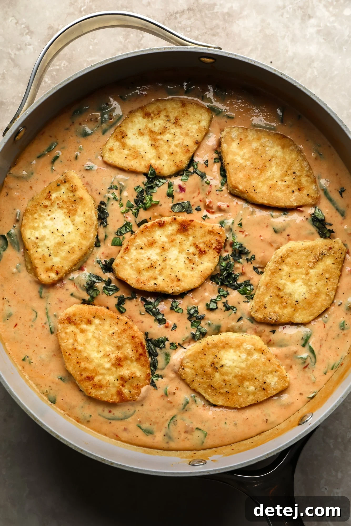 Fried tofu pieces beautifully coated in the creamy Marry Me Tofu sauce in a skillet, ready to serve.
