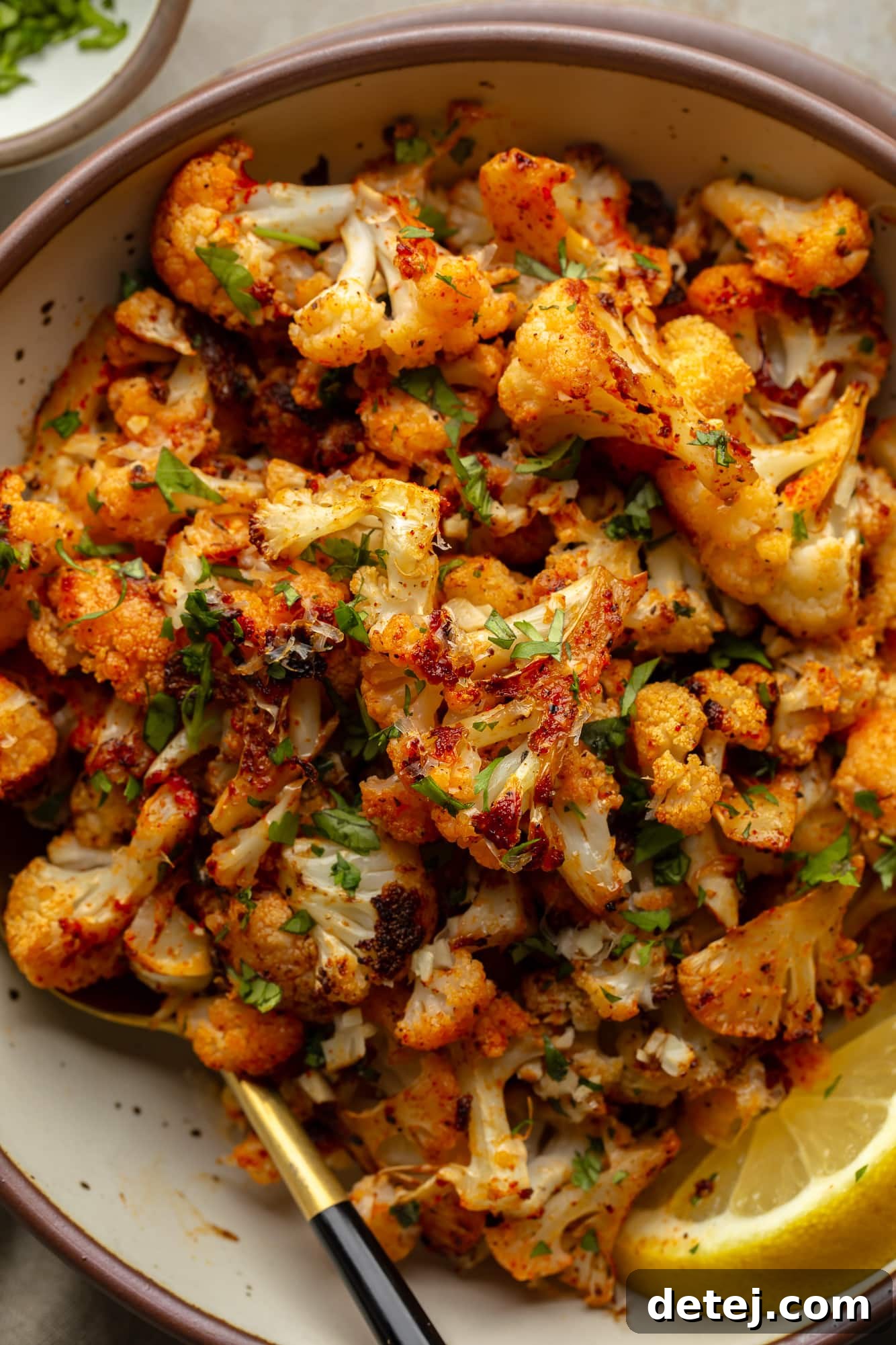 roasted cauliflower florets in a white bowl.