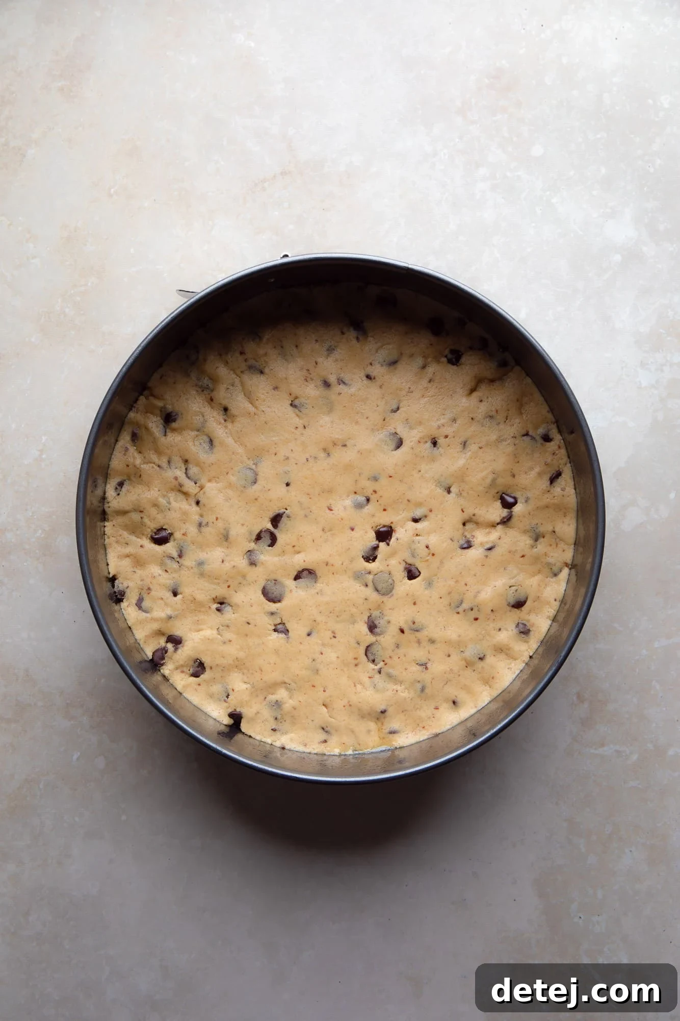 Ultimate Vegan Cookie Cake 4 overhead view of an unbaked vegan cookie cake in a cake pan.