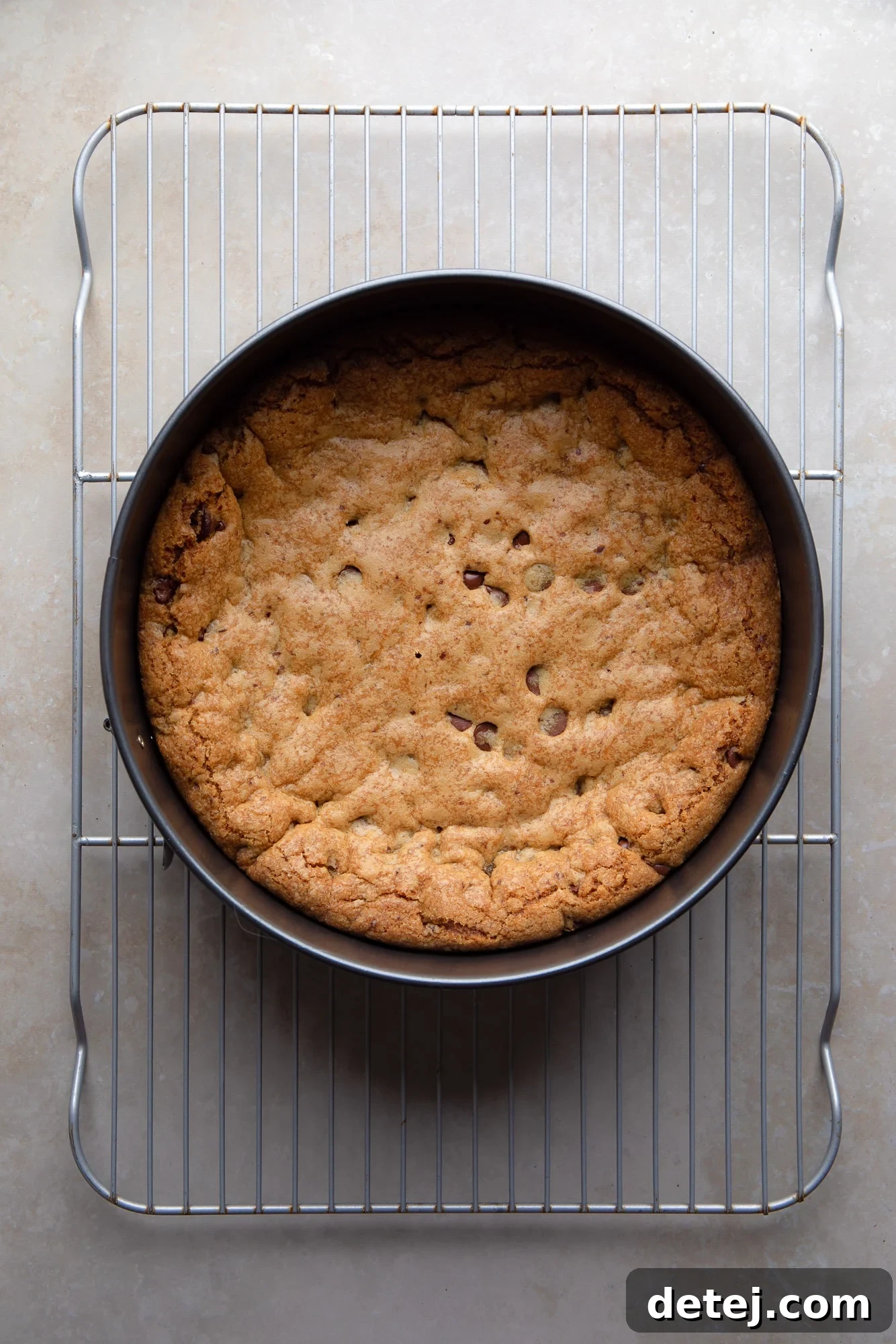 Ultimate Vegan Cookie Cake 5 overhead view of a baked vegan cookie cake in a cake pan.