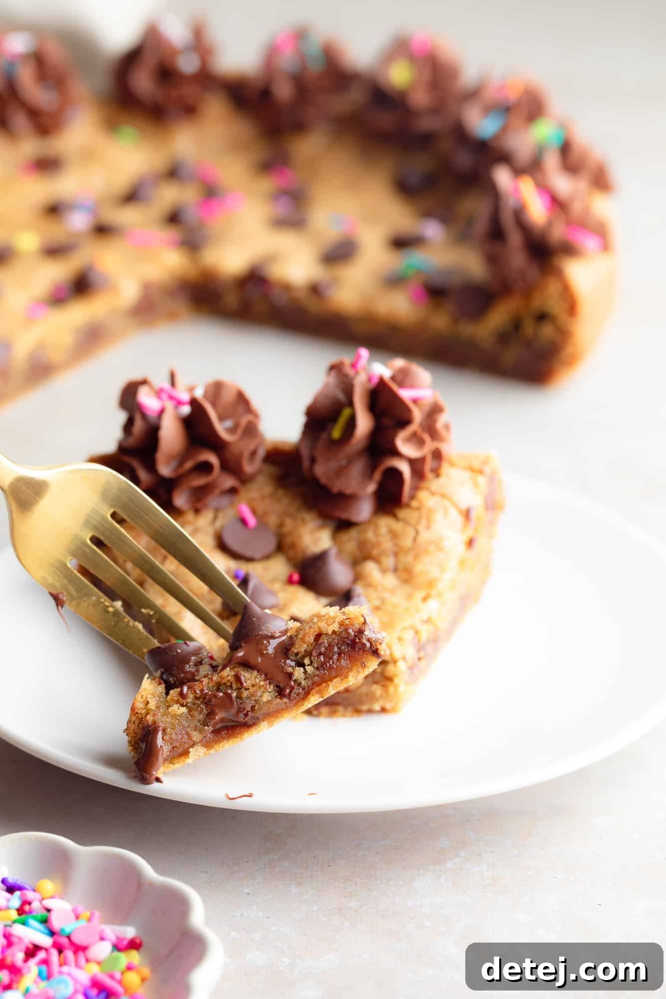 Ultimate Vegan Cookie Cake 9 close up on a fork holding a bite of a vegan cookie cake.