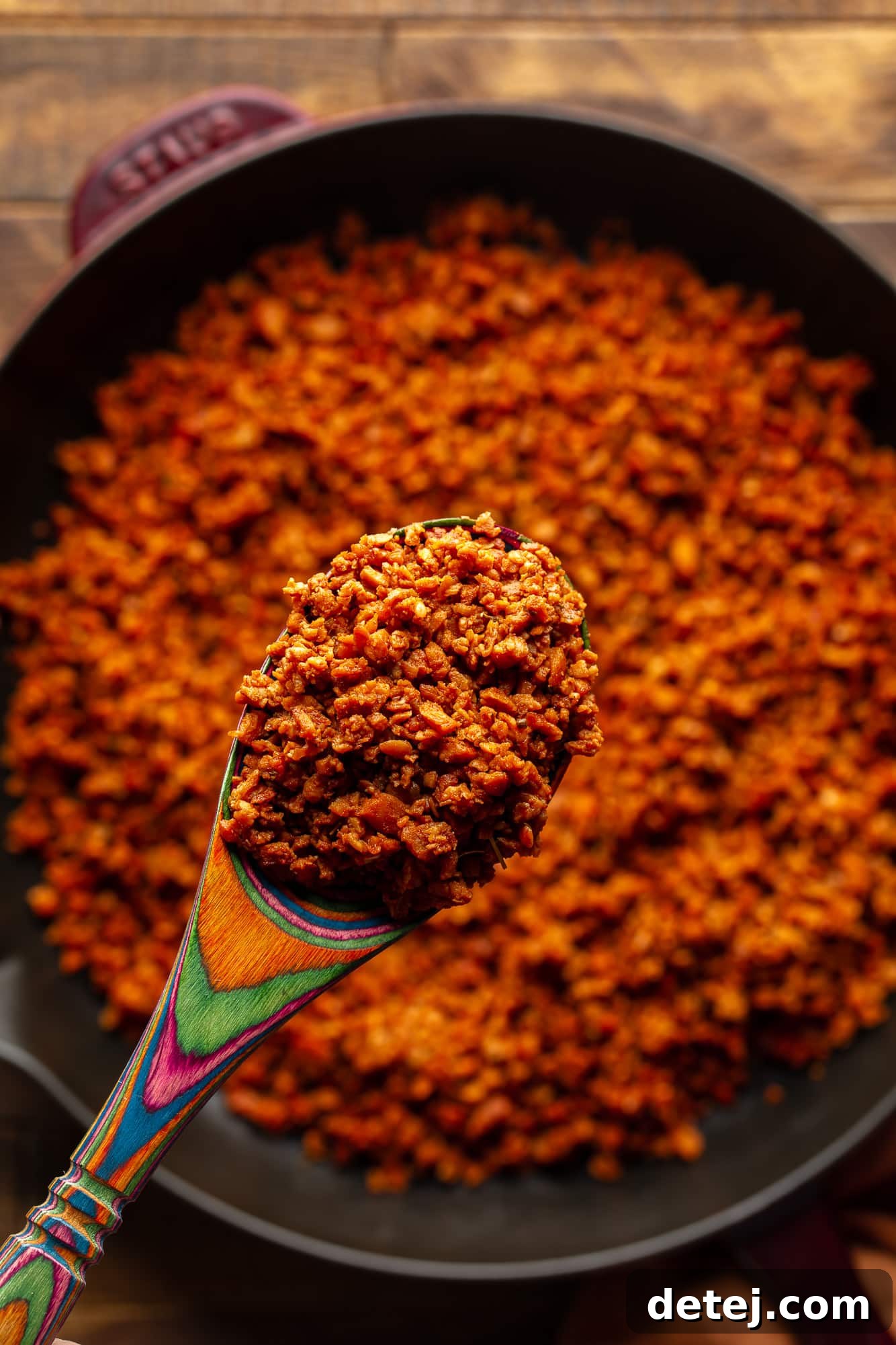 Plant-Based Chorizo 4 Close-up of a wooden spoon holding a generous scoop of perfectly cooked, richly spiced vegan chorizo crumbles, ready for serving.