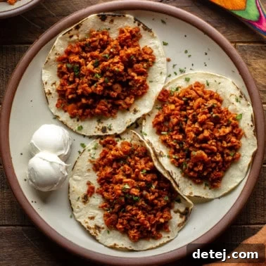 Plant-Based Chorizo 6 three tortillas topped with vegan chorizo on a plate.