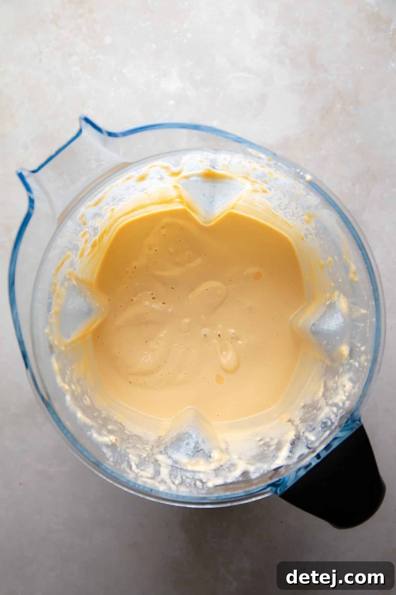 The smoothly blended, creamy cashew sauce for the vegan Mexican Street Corn Dip, swirling in a high-powered blender.