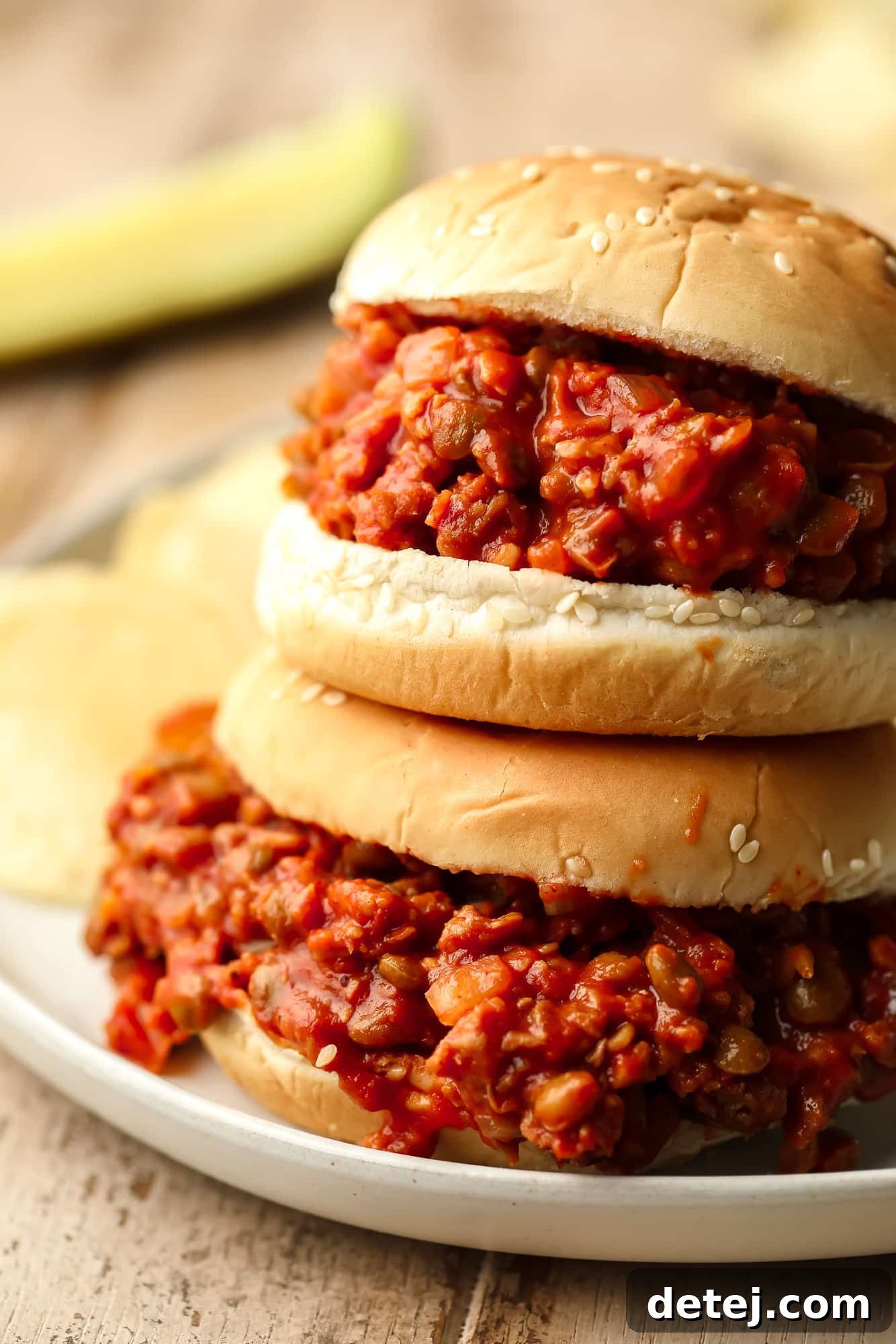 close up on two vegan sloppy joes served in hamburger buns.