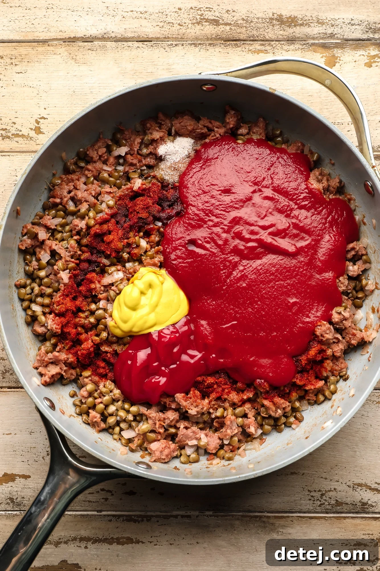 making a vegan sloppy joe filling in a large skillet.