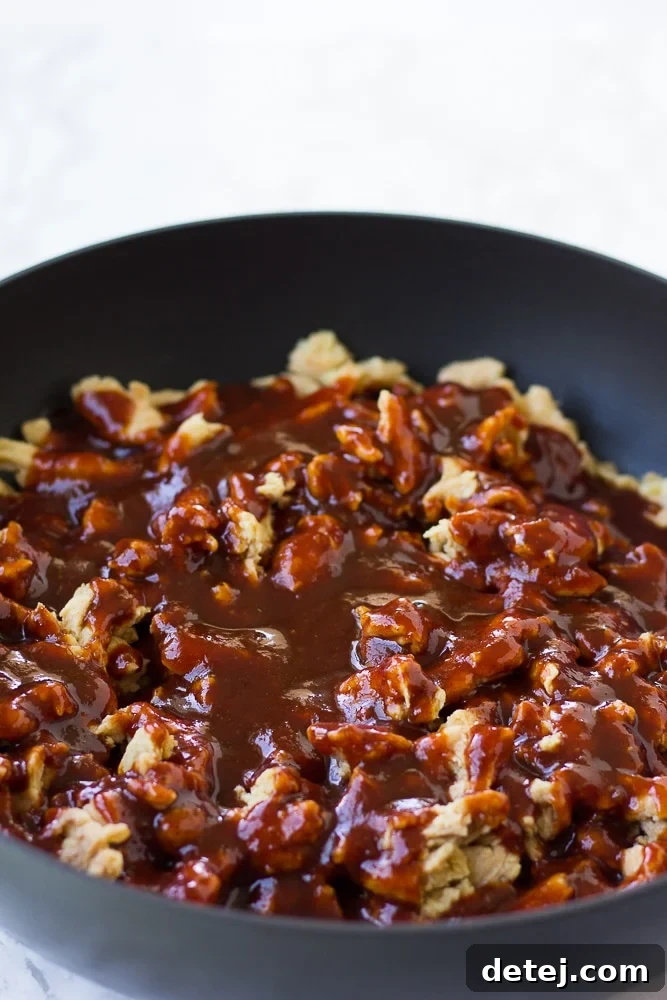 Ultimate Vegan BBQ Soy Curl Sandwich 4 soy curls with bbq sauce on top in pan