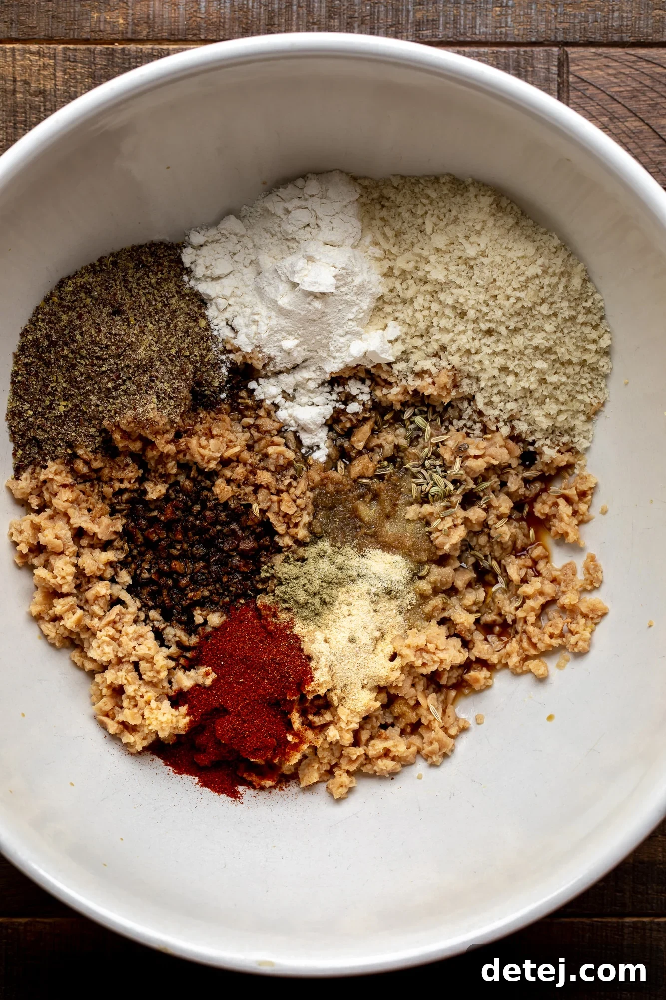 the ingredients for vegan breakfast sausages in a large white bowl.