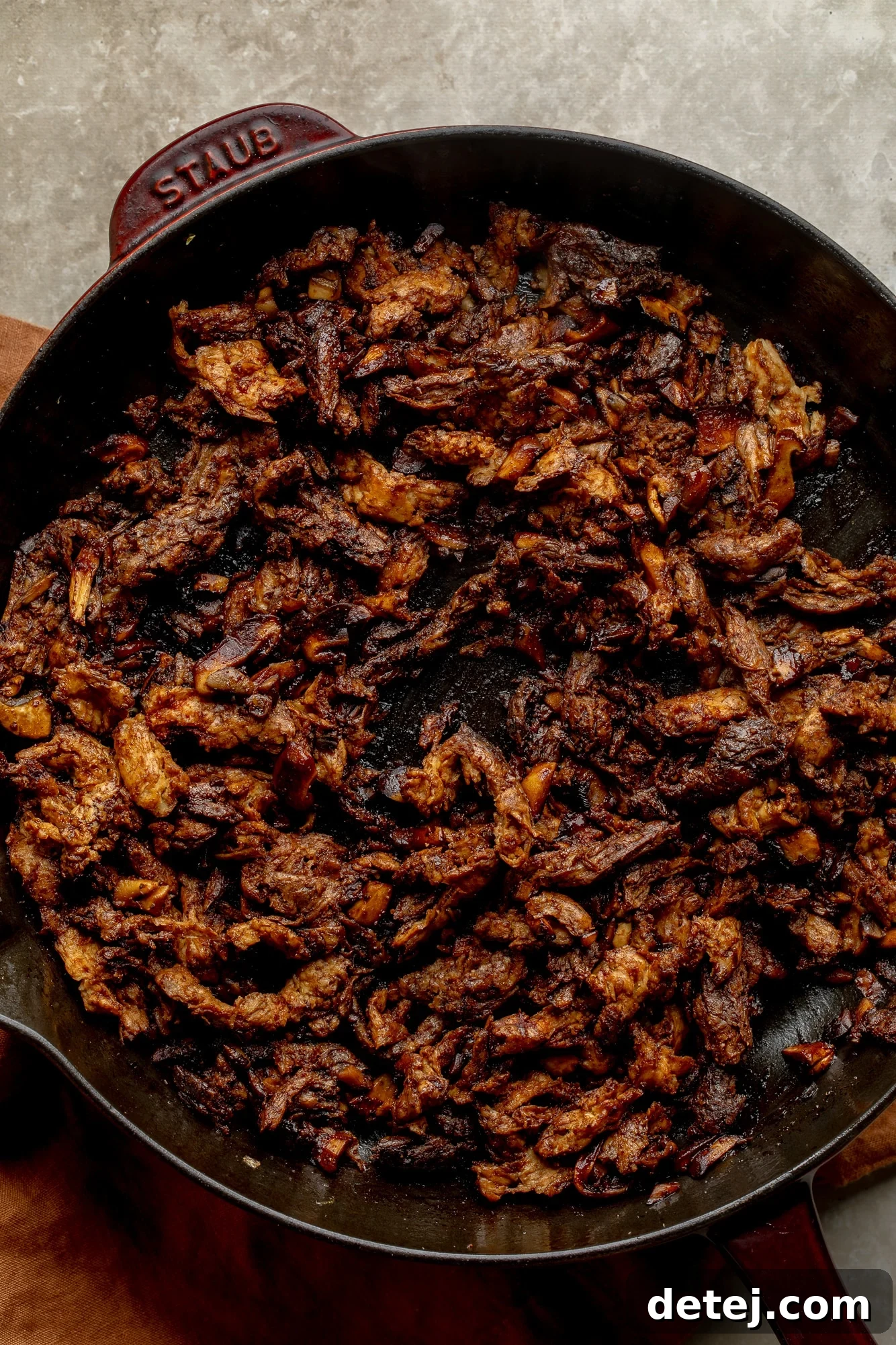 Plant-Based Philly Delight 4 Cooking a soy curl filling for vegan philly cheesesteak sandwiches in a large skillet.