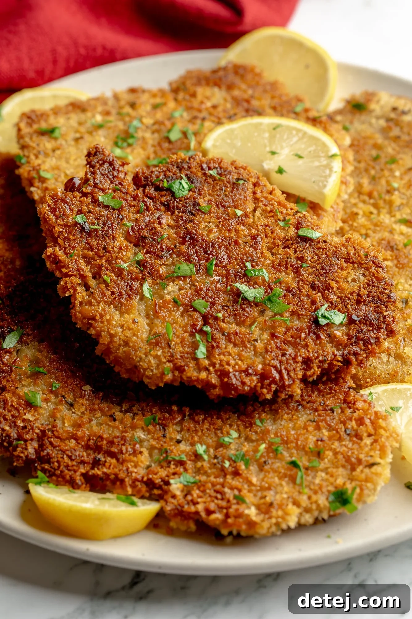 Close-up on a plate of golden breaded vegan cutlets, ready to serve.