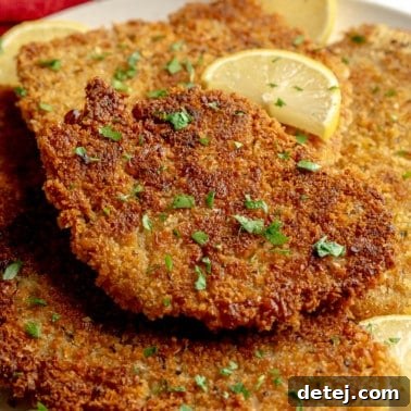 Close up on a plate of golden breaded vegan cutlets.