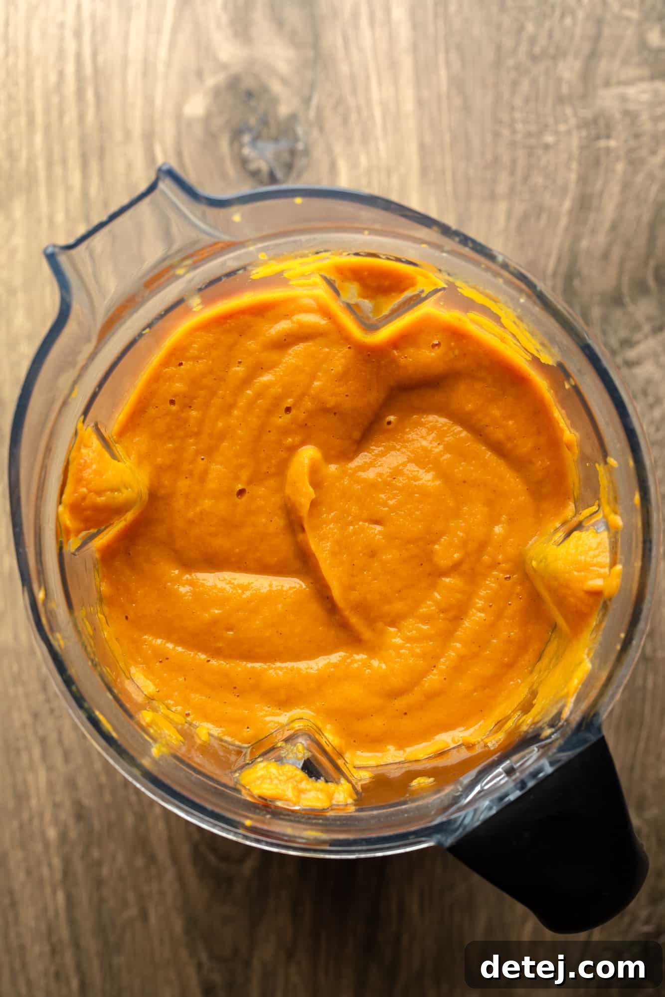 Golden Carrot Ginger Comfort 5 a blender full of smooth carrot and ginger soup.