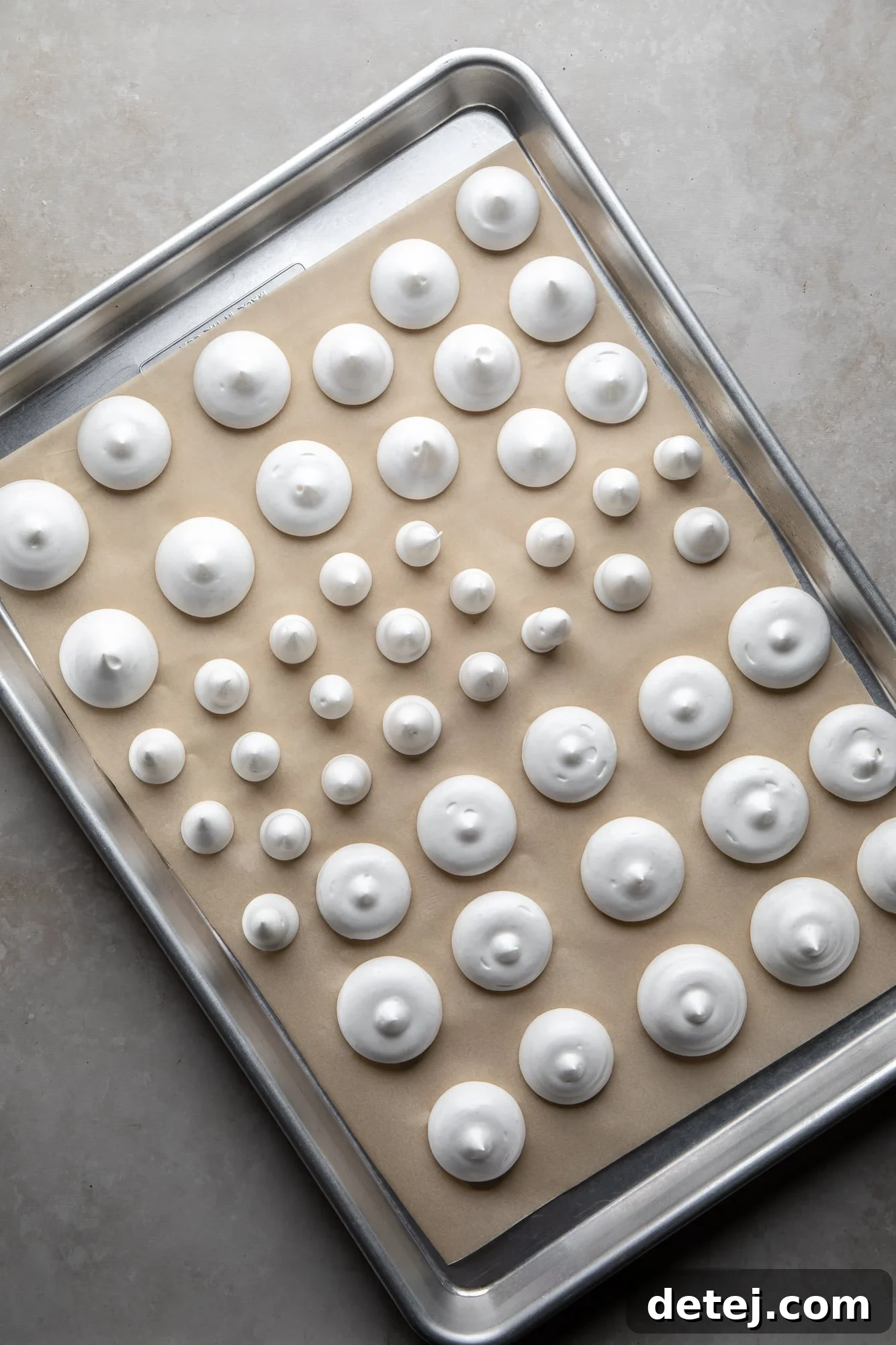 overhead view of vegan meringues on a baking sheet.