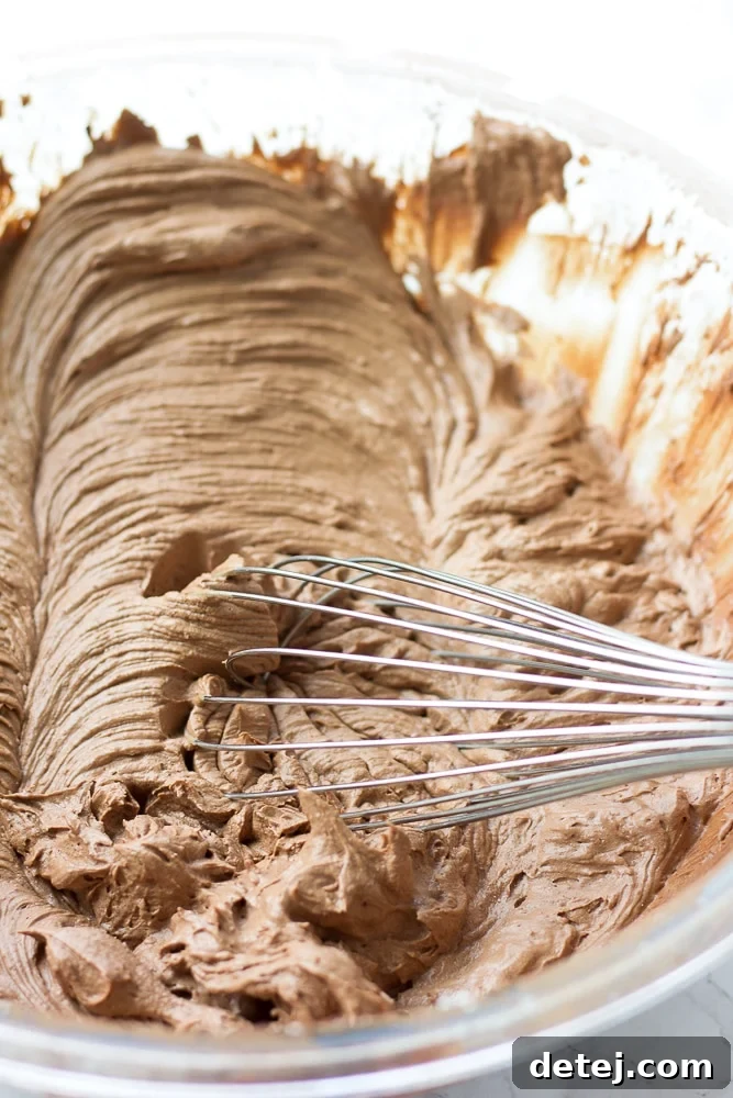 vegan chocolate frosting in a bowl with a whisk