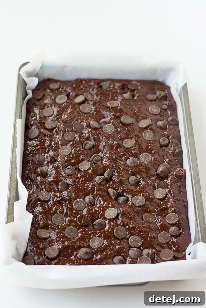 Vegan brownies batter in pan with parchment paper