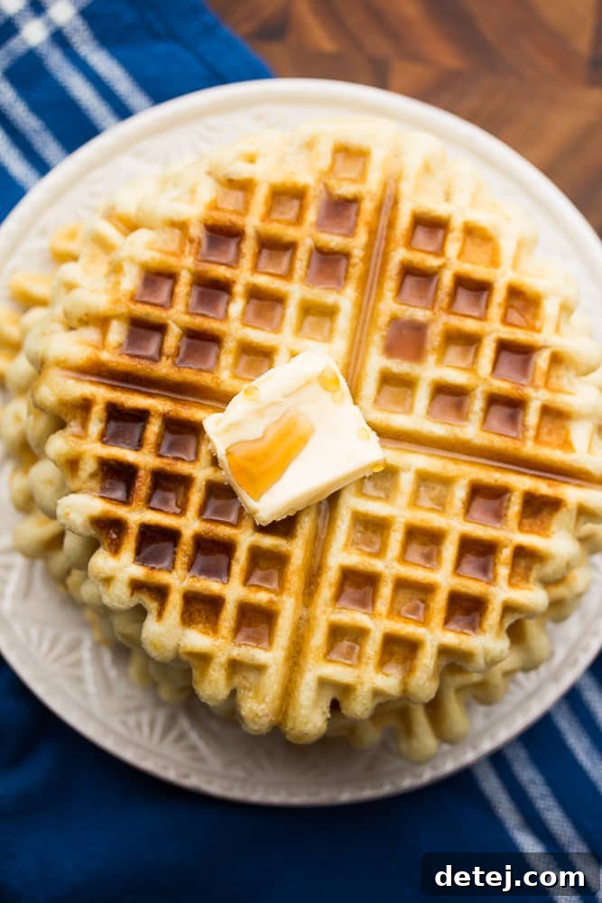 Fluffy Vegan Gluten-Free Waffles 2 Looking down on a plate of crispy vegan gluten-free waffles with syrup and butter