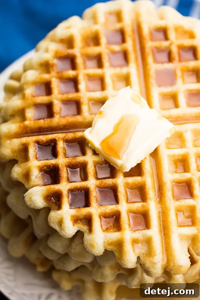 Fluffy Vegan Gluten-Free Waffles 3 Close up of vegan gluten-free waffles with a blue towel and butter