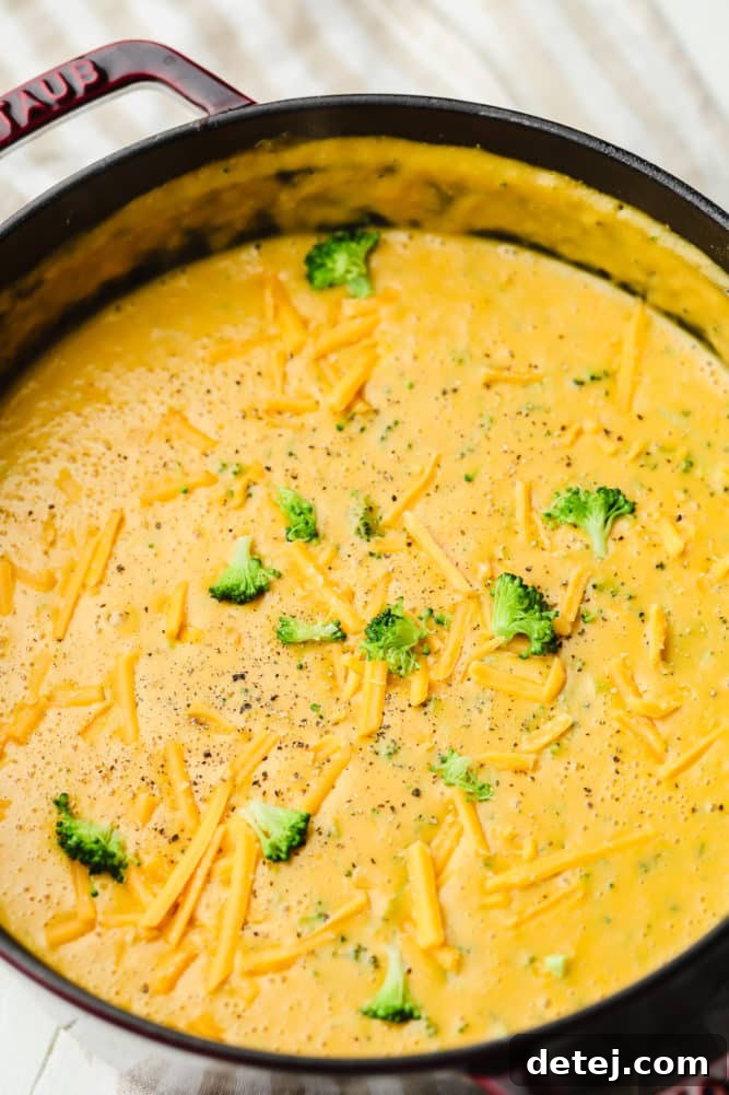 Velvety Vegan Broccoli Cheddar Soup 7 a large black pot filled with vegan broccoli cheddar soup.