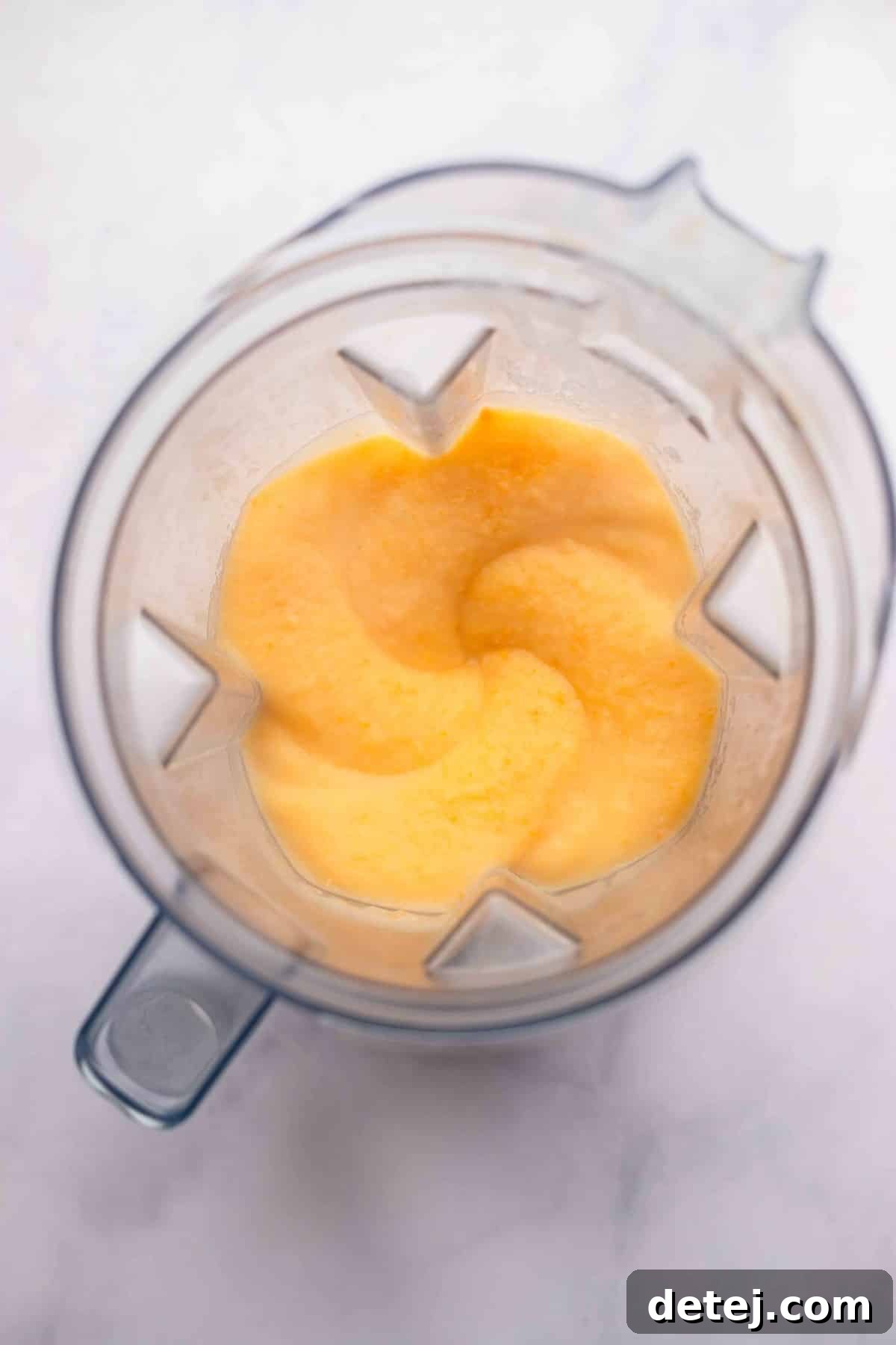blender with creamy orange mixture