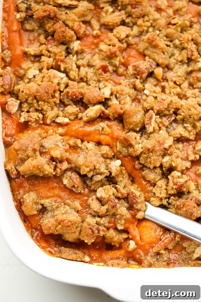 Comforting Vegan Sweet Potato Bake 2 spoon in sweet potato casserole, close up