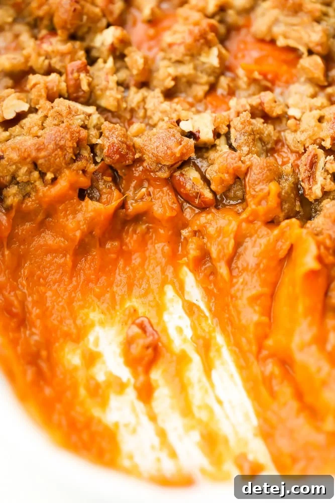 Comforting Vegan Sweet Potato Bake 3 close up of scooped out sweet potatoes from casserole dish