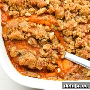 Comforting Vegan Sweet Potato Bake 9 square image of casserole dish with sweet potatoes and pecan topping