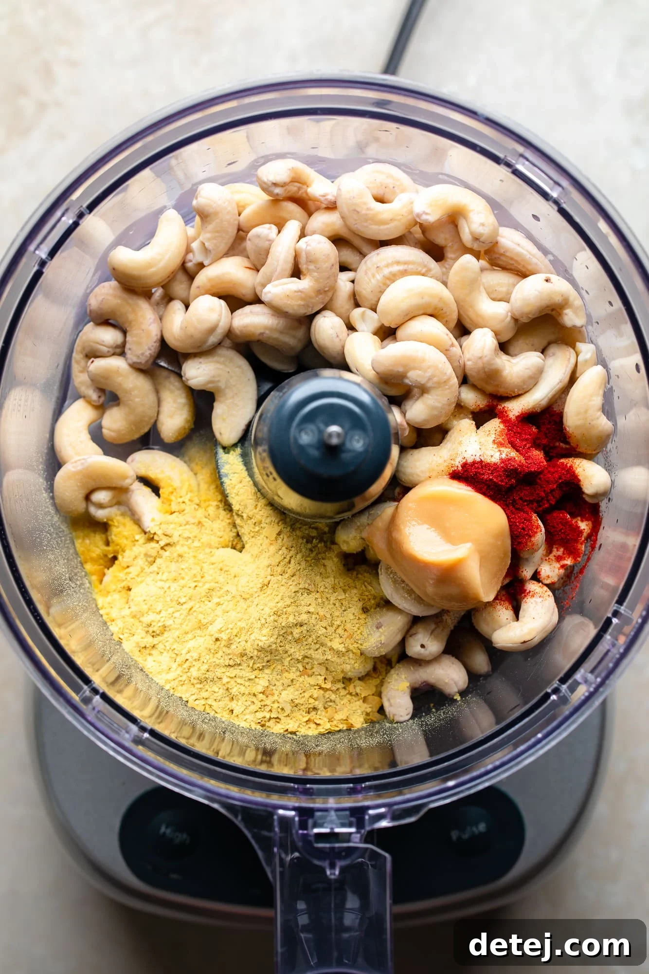 the ingredients for a vegan cheese ball in a food processor.