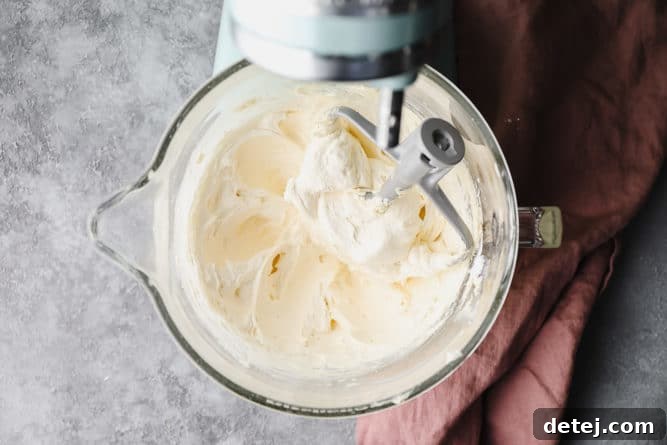 Dreamy Vegan Buttercream 7 A mixing bowl filled with creamy, smooth white vegan buttercream frosting, ready for use.