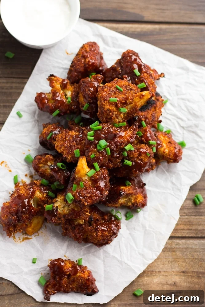 a lot of bbq cauliflower wings on parchment paper