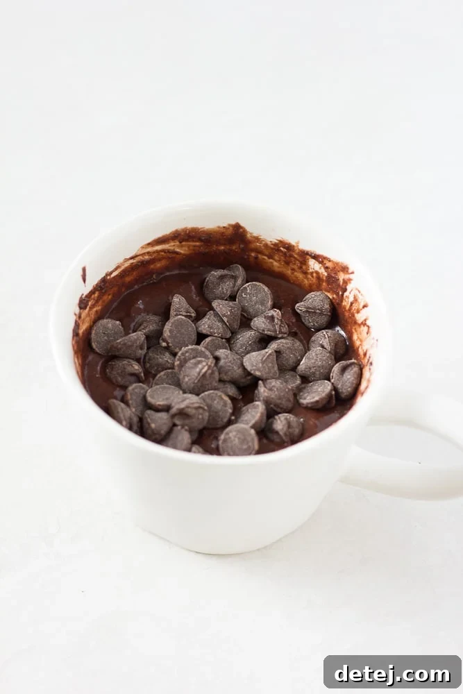 Uncooked vegan chocolate mug cake batter in a mug, ready for the microwave
