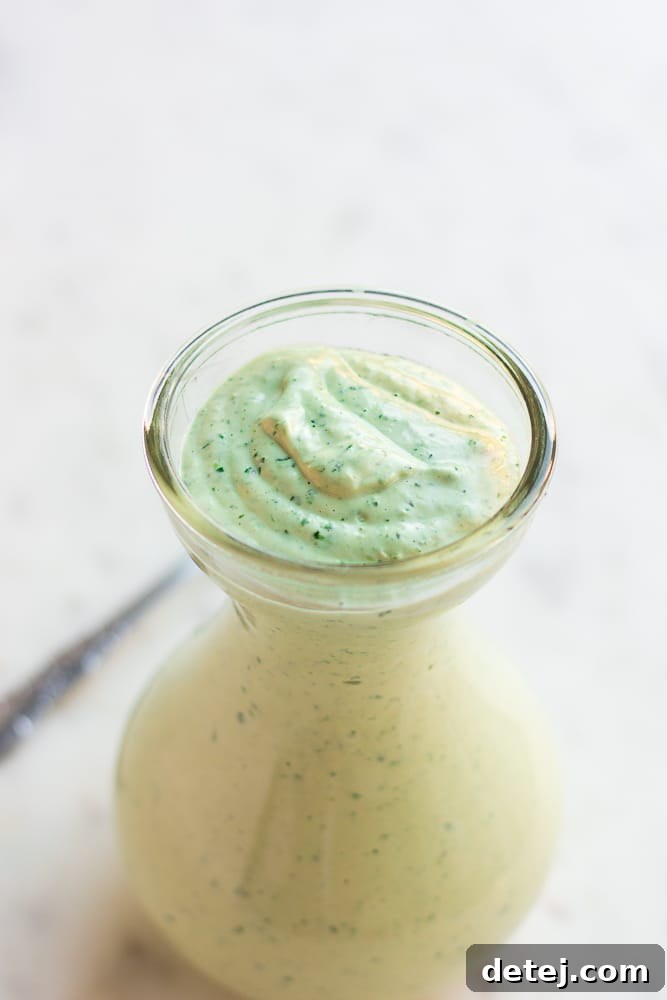 Luscious Vegan Green Goddess Dressing 8 Small glass dish filled with creamy vegan green goddess dressing, ready for serving.